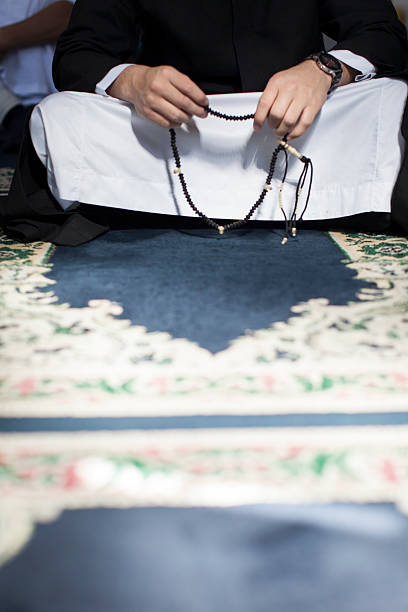 istock Young Muslim man holding the holy neckless before pray. 462968981