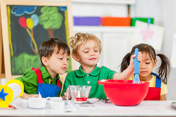 istock Group of kids making cookies 462970819