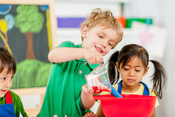 istock Group of kids making cookies 462970831
