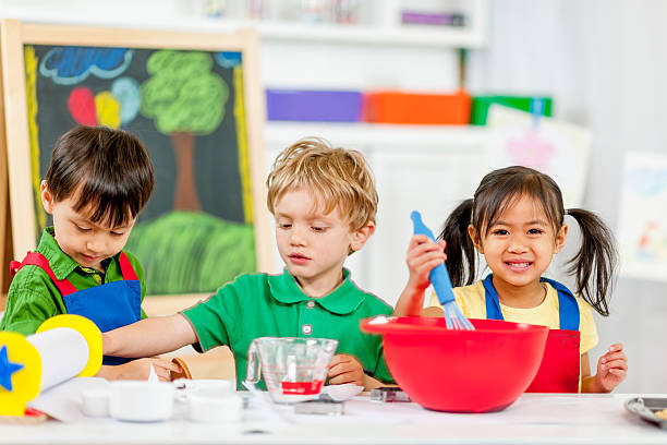 istock Group of kids making cookies 462970835