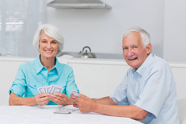 istock Smiling couple playing cards 462973291