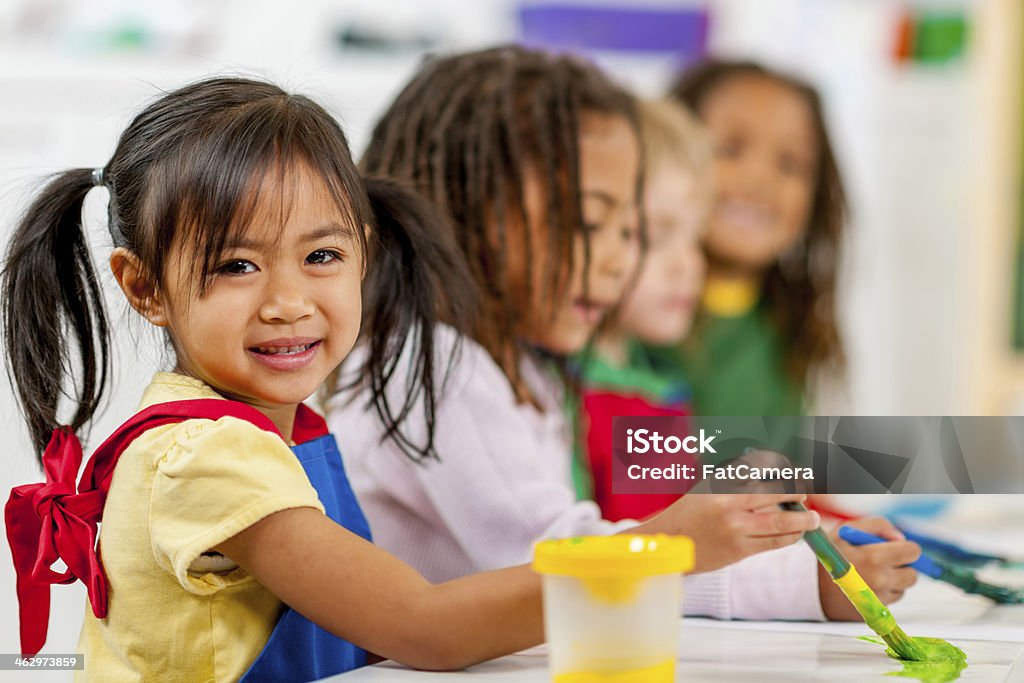 Kids painting for fun Group of preschool kids painting in the classroom 2-3 Years Stock Photo