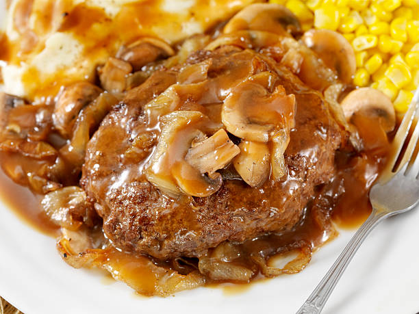 Salisbury Steak Salisbury Steak Topped with Sauteed Mushrooms and Onions, Mashed Potatoes and Corn on the side and topped with Gravy. - Photographed on Hasselblad H3D2-39mb Camera salisbury steak stock pictures, royalty-free photos & images