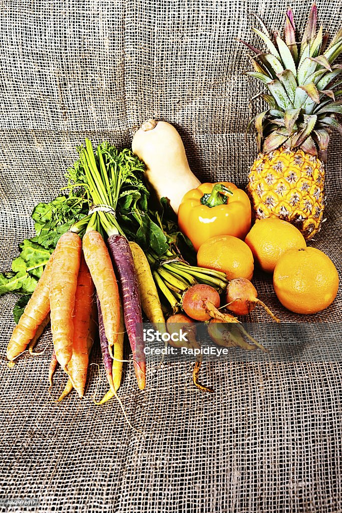 Golden goodness: Beta-carotene rich vegetables and fruit A rustic collection of golden-toned fresh produce. Yellow vegetables are particularly high in beta-carotene, an antrioxidant and precursor of essential Vitamin A. Burlap Stock Photo