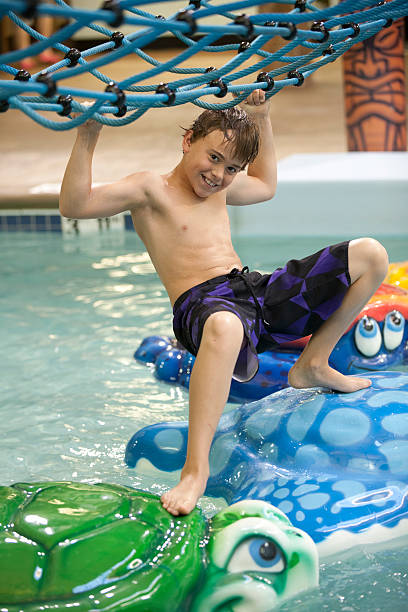 istock Young boy playing at the indoor water park 462979333