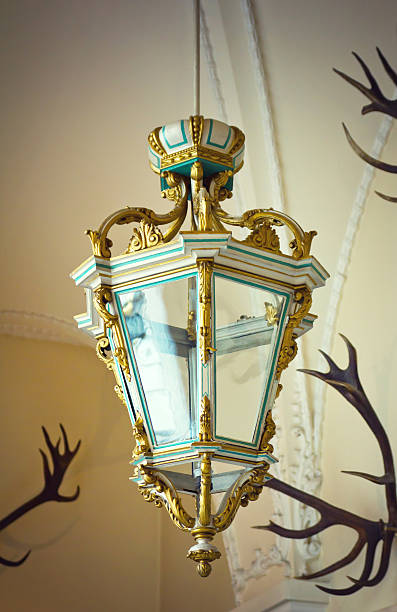 Old antique lamp Old antique lamp with antlers on a wall. antler chandelier stock pictures, royalty-free photos & images