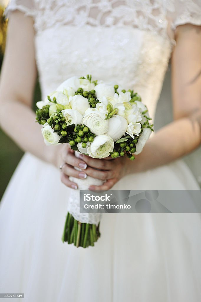 Wedding bouquet in hands of the bride Beautiful wedding bouquet in hands of white bride Beauty Stock Photo