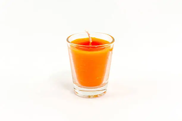 Beautiful colorful candle in glass isolated on white background.