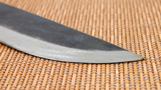 Traditional machete blade on a mat