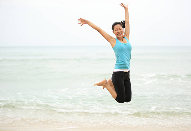 istock Happy woman jumping on the beach. summer holidays 462995481
