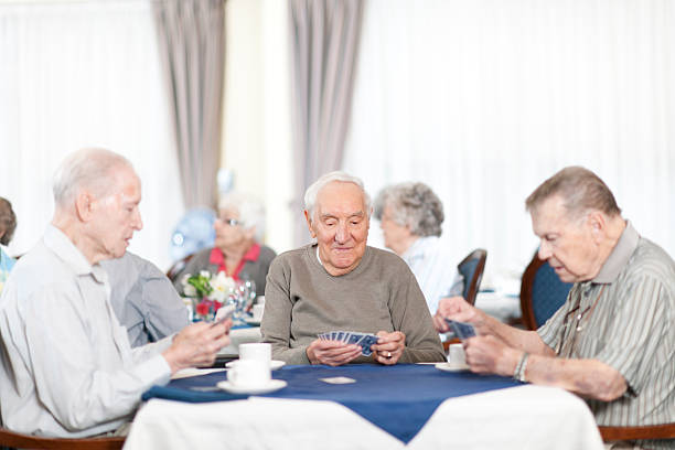istock Group of senior people playing card 463026589