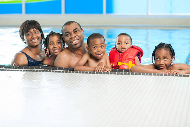 istock Black family having fun in swimming pool 463026661
