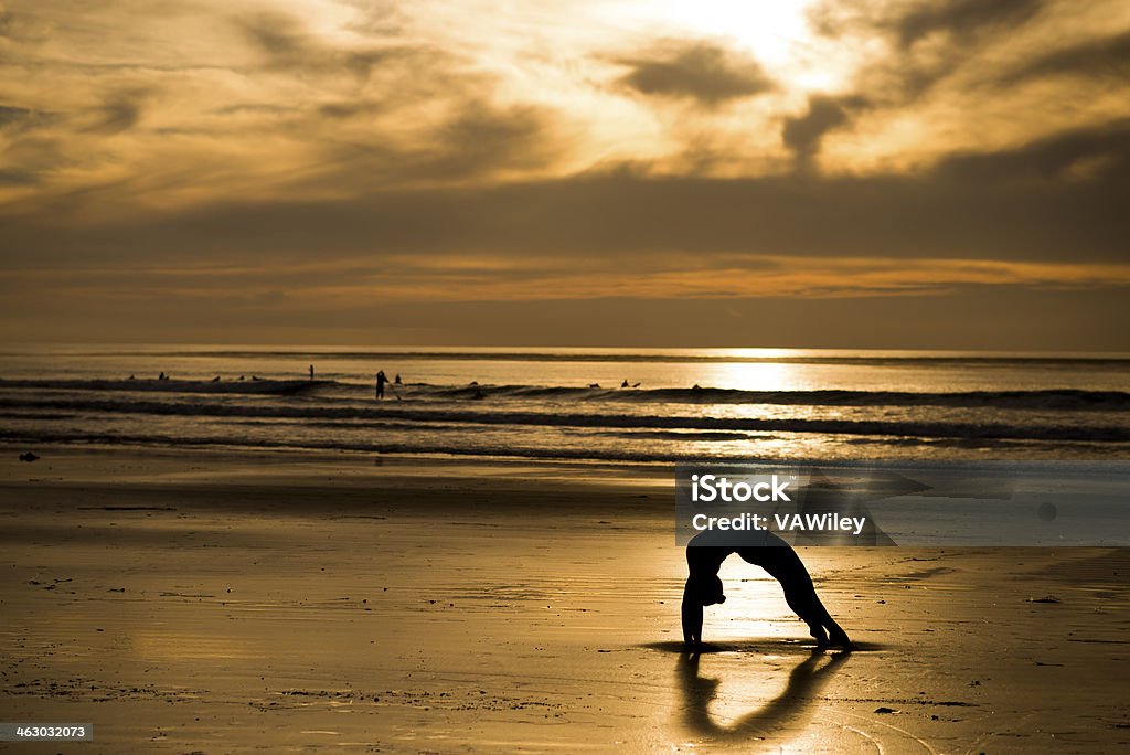 shadow Girl exercising on the beach Achievement Stock Photo