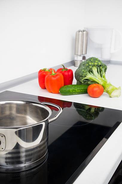 istock Pot and vegetables in modern kitchen with induction stove 463035087