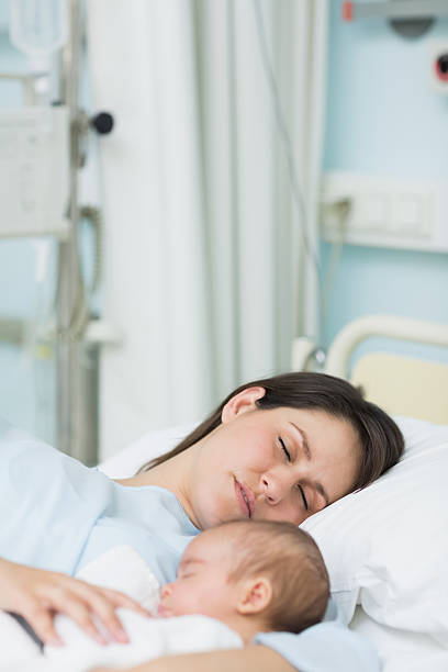 istock Mother and newborn baby sleeping in the same bed 463037515