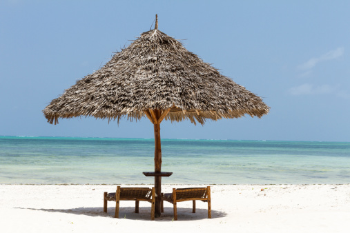 Madera con sombrilla y sillas de playa en Zanzíbar photo