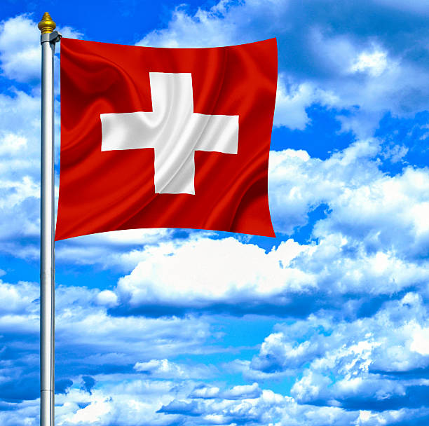 istock Swiss waving flag against blue sky 463043341
