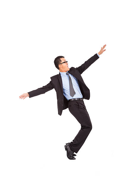 istock businessman feel happy to raise his hands and dancing.. 463043709