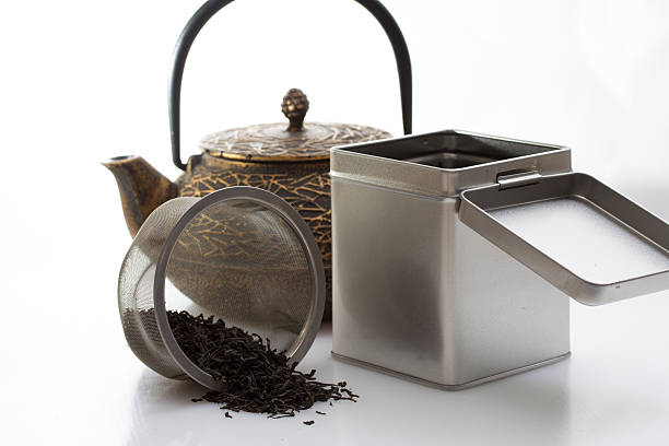 istock Black iron asian teapot and burning candle,vintage style. 463043755