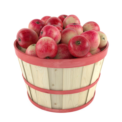 Wooden barrel with apples at the white background