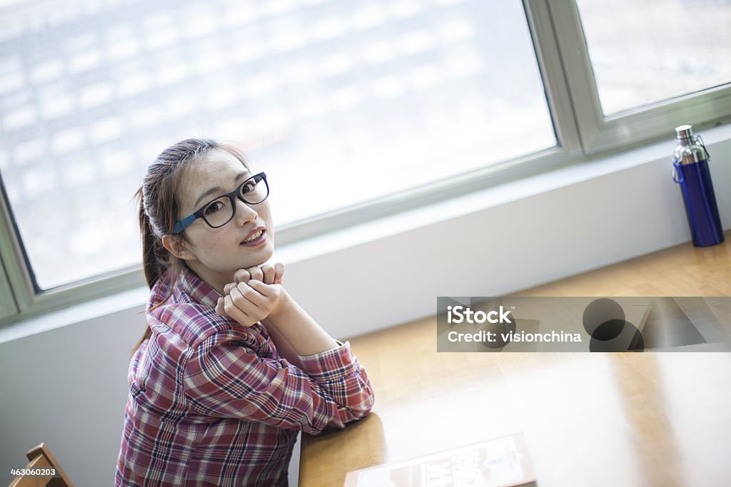 young woman in a library young woman reading in a library 20-29 Years Stock Photo