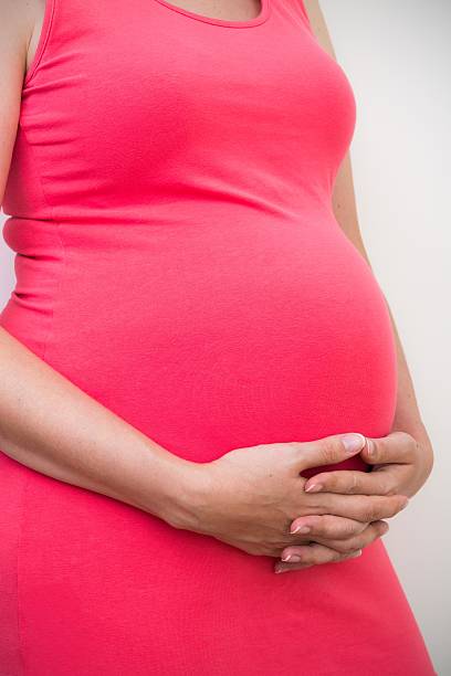 istock Pregnant woman touching her belly 463060555