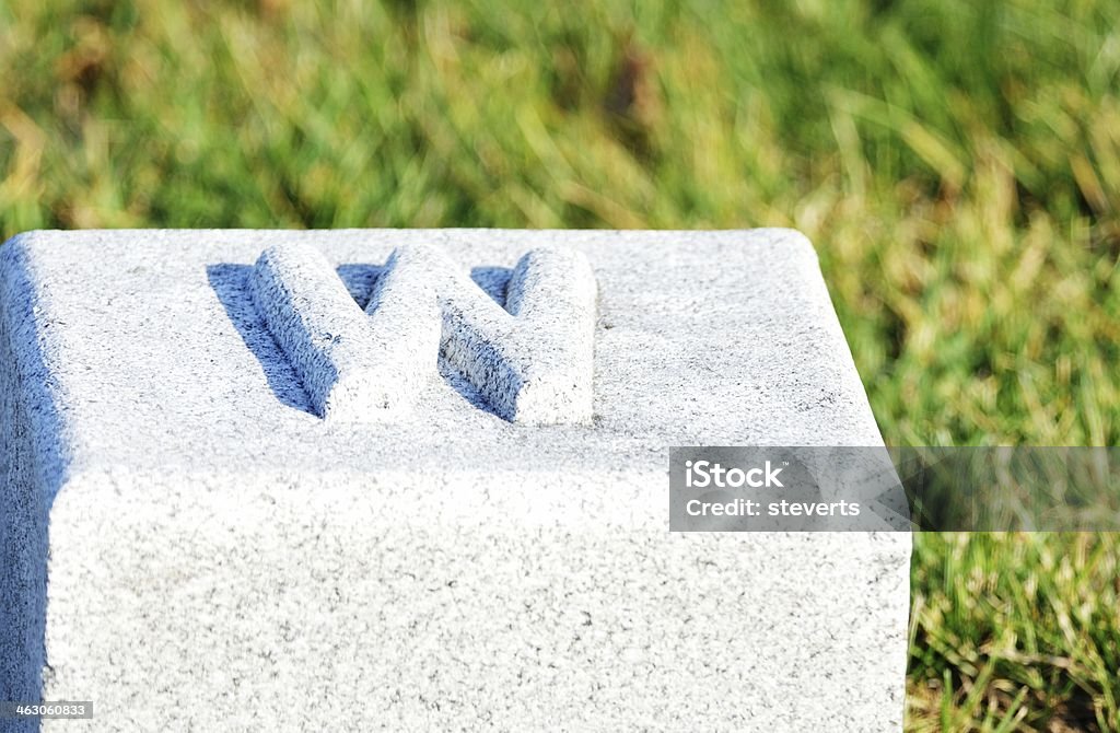 West Marker Granite "W" marker in the cemetery. Cemetery Stock Photo