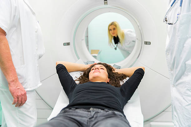 istock Chief radiologist,young doctor and  patient,having PET scan 463070629