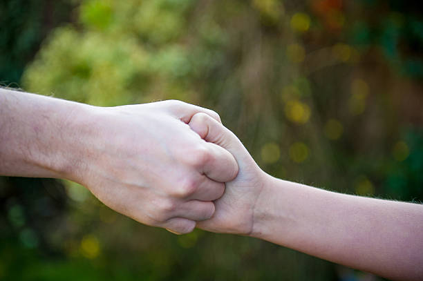 istock Child holding Adult Hand 463078829