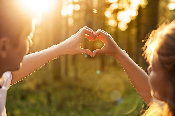istock couple in love doing hands heart 463079289