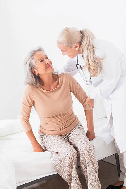 istock Doctor helping woman sit up 463079799