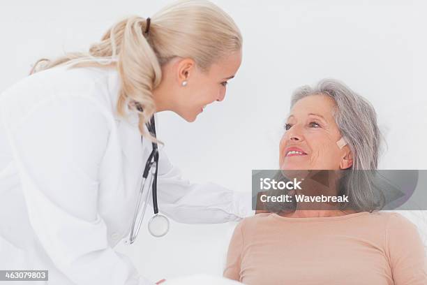 Doctor Taking Care Of Elderly Woman Stock Photo - Download Image Now - 20-29 Years, 70-79 Years, Active Seniors