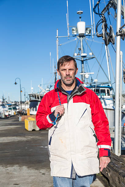 istock Sailor in foul weather jacket walks down the dock 463080763