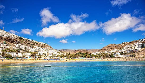 Panoramic view on the beautiful beach of the tourist resort town of Puerto Rico, Gran Canaria (Spain)