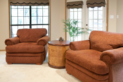 Rust-colored arm chairs in cozy family living room.