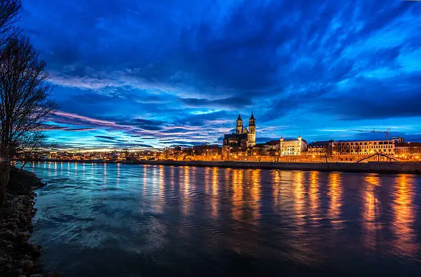 The Cathedral of Magdeburg (Magdeburger Dom) and the River Elbe on a beautiful winter evening sunset.