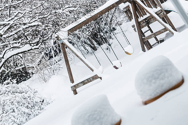 istock Back Yard Swingset Buried in Blizzard Snow 463087929