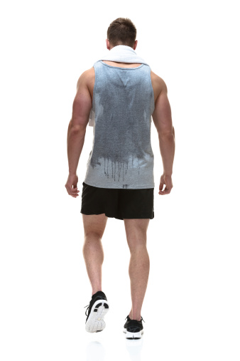 Rear view of man walking with towel on shoulderhttp://www.twodozendesign.info/i/1.png