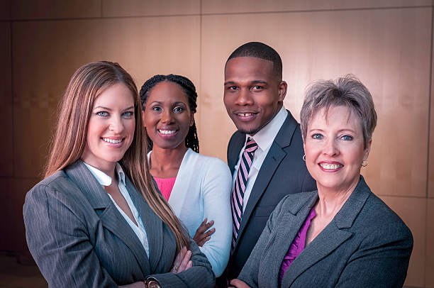Group of diverse businesspeople standing with their senior executive (III)