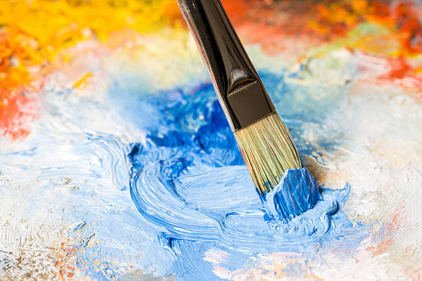 istock Paintbrush with blue oil paint on a classical palette 463098851