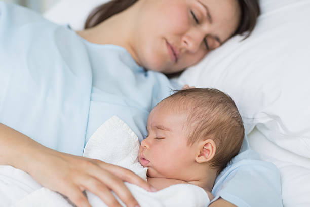 istock Mother and baby boy sleeping in the same bed 463101139