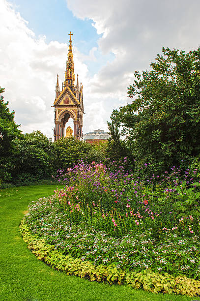 Albert Memorial The Albert Memorial in London taken from the gardens in Hyde Park. The top of the Royal Albert Hall can also be seen. The Albert Memorial was built as a memorial to Prince Albert from his wife Queen Victoria. royal albert hall stock pictures, royalty-free photos & images