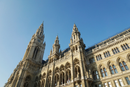 The facade and towers of the neo-gothic town hall of Vienna photographed against a clear blue sky in late autumn.