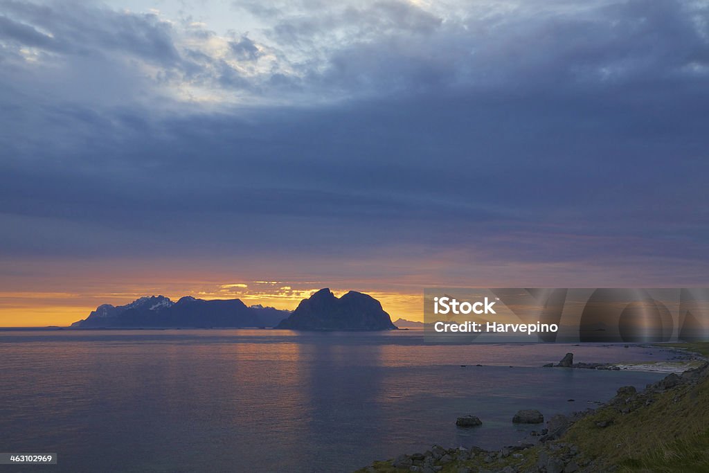 Midnight sun in Scandinavia Scenic cloudscape with midnight sun over the Lofoten islands in Norway in summer Coastline Stock Photo