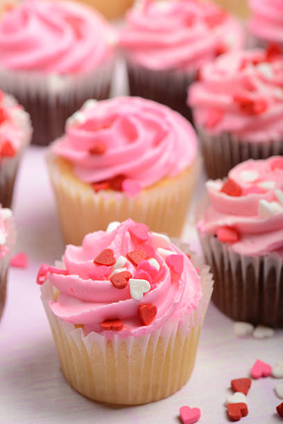 istock Pink Holiday Cupcakes with Heart Candies 463103541