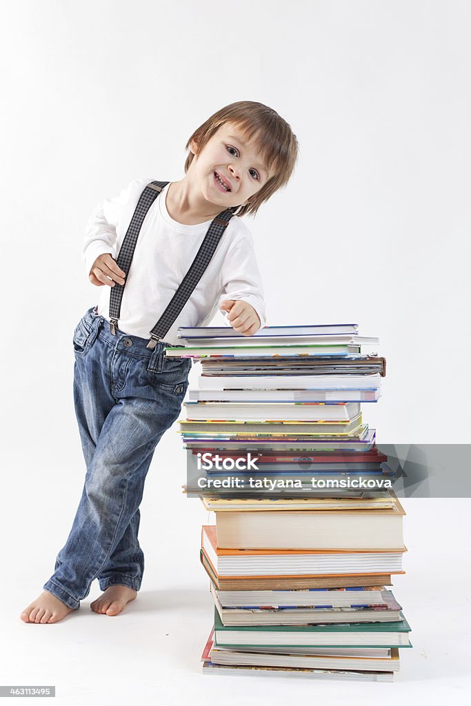 Little sweet boy with a pile of books Adult Student Stock Photo