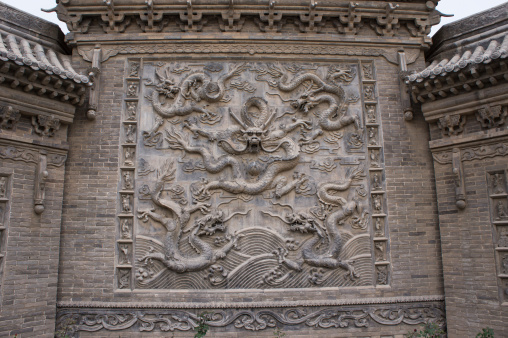 This tranquil scene captures the spirit of deep autumn at Qingyang Palace, featuring a stone dragon sculpture gracing the weathered walls of the Taoist temple. The subdued colors of fall create a serene ambiance, allowing the intricate details of the timeless dragon carving to stand out against the historical backdrop of the temple. Captured with the Leica Q3.