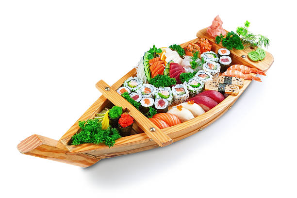 Collection of species sushi on the decorative plate ship. Collection of species sushi on the decorative plate ship. On a white background. wasabi sauce stock pictures, royalty-free photos & images