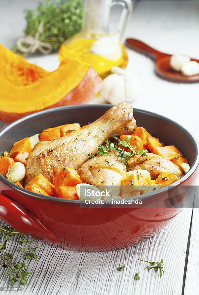 Chicken baked with pumpkin Pumpkin baked with chicken in the red ceramic form Baked Stock Photo