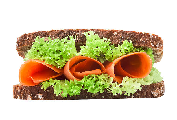 istock Salmon sandwich with fresh salad on the white background 463121503